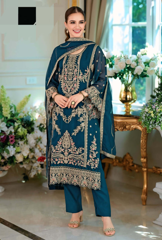 Model showcasing a Gama Green embroidered organza salwar suit with intricate designs, perfect for festive occasions.