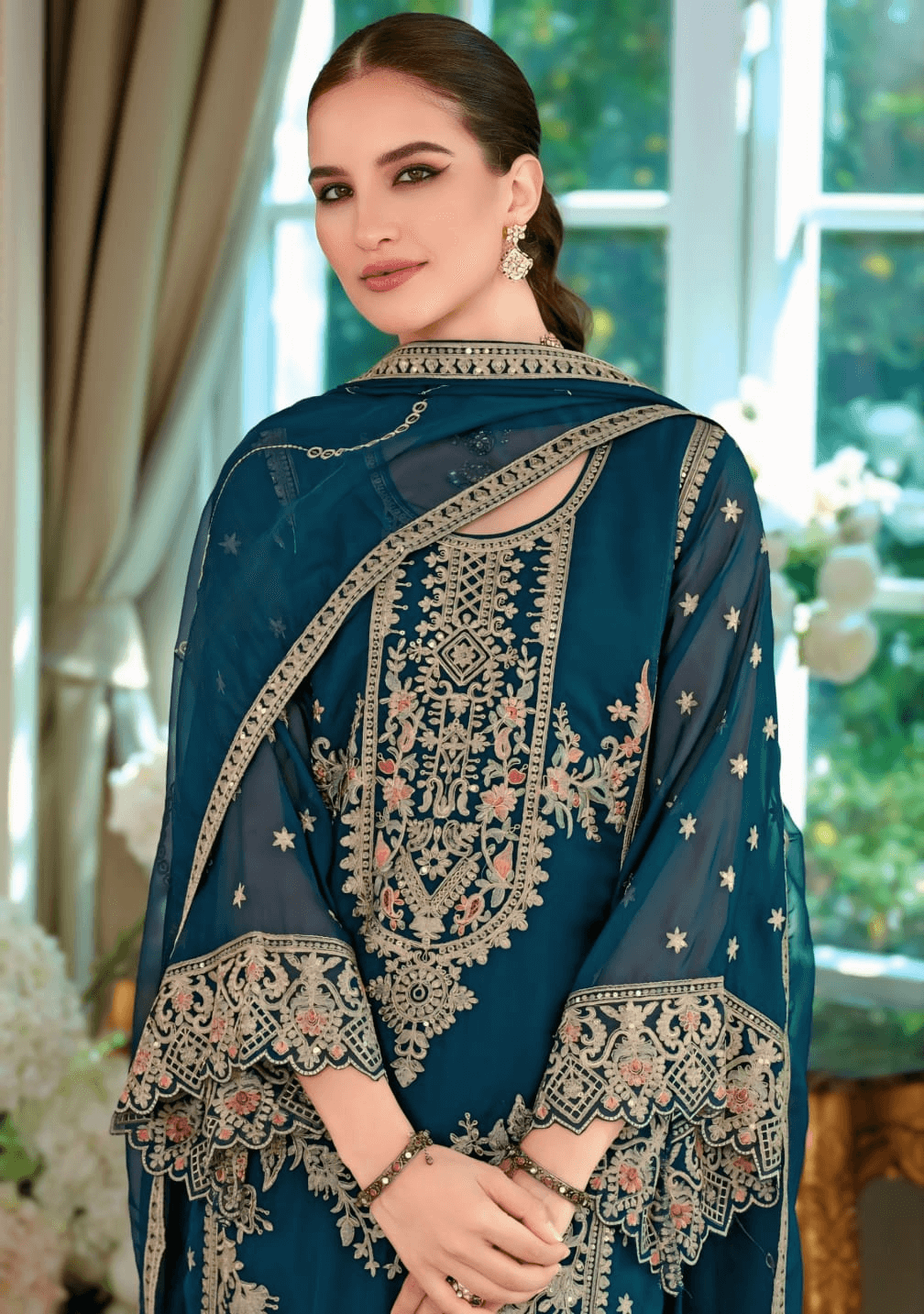 Elegant woman wearing a Gama Green embroidered organza salwar suit showcasing intricate embroidery and traditional style.