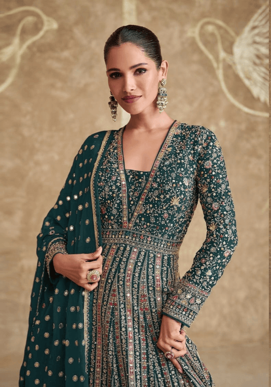 Elegant green designer Anarkali gown with intricate embroidery and sequins, worn with matching dupatta.